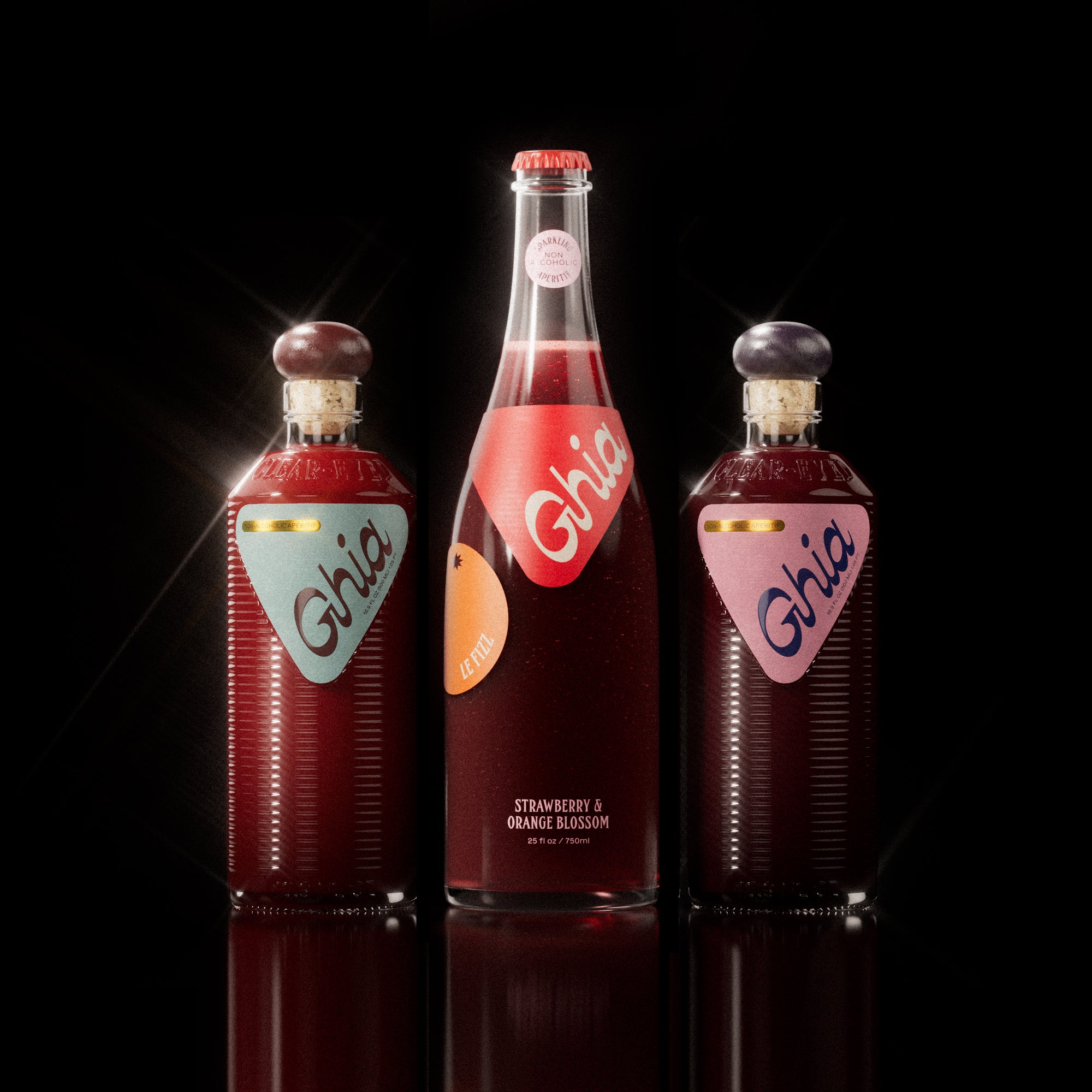 Ghia Bottle Bundle featuring a 750ml bottle of Le Fizz and two 500ml bottles of the Apéritif in Original and Berry flavors, arranged on a reflective white background. A non-alcoholic beverage set designed for mindful drinking.