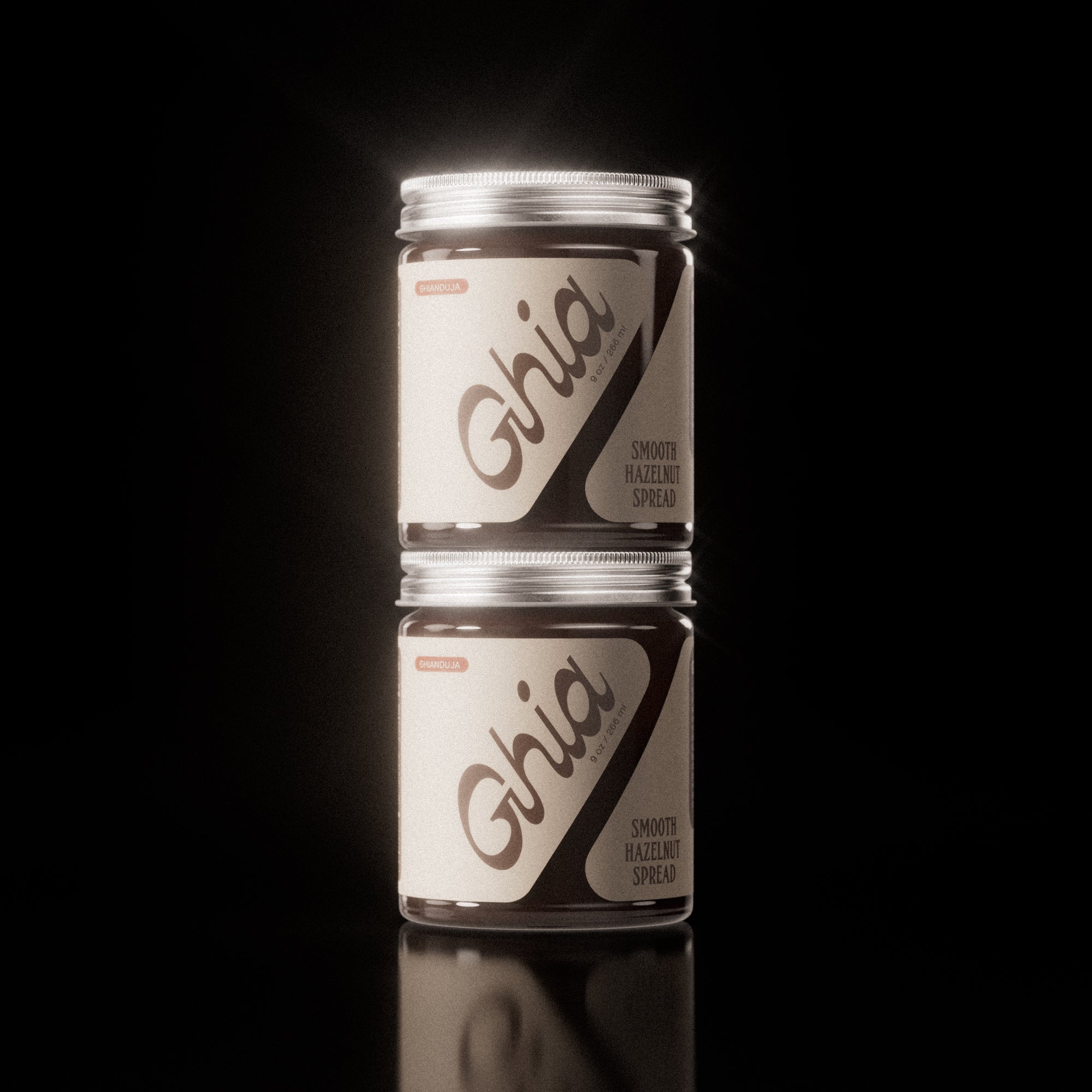 Two stacked jars of chocolate Hazelnut Spread with beige labels and bold brown branding on clear glass containers.