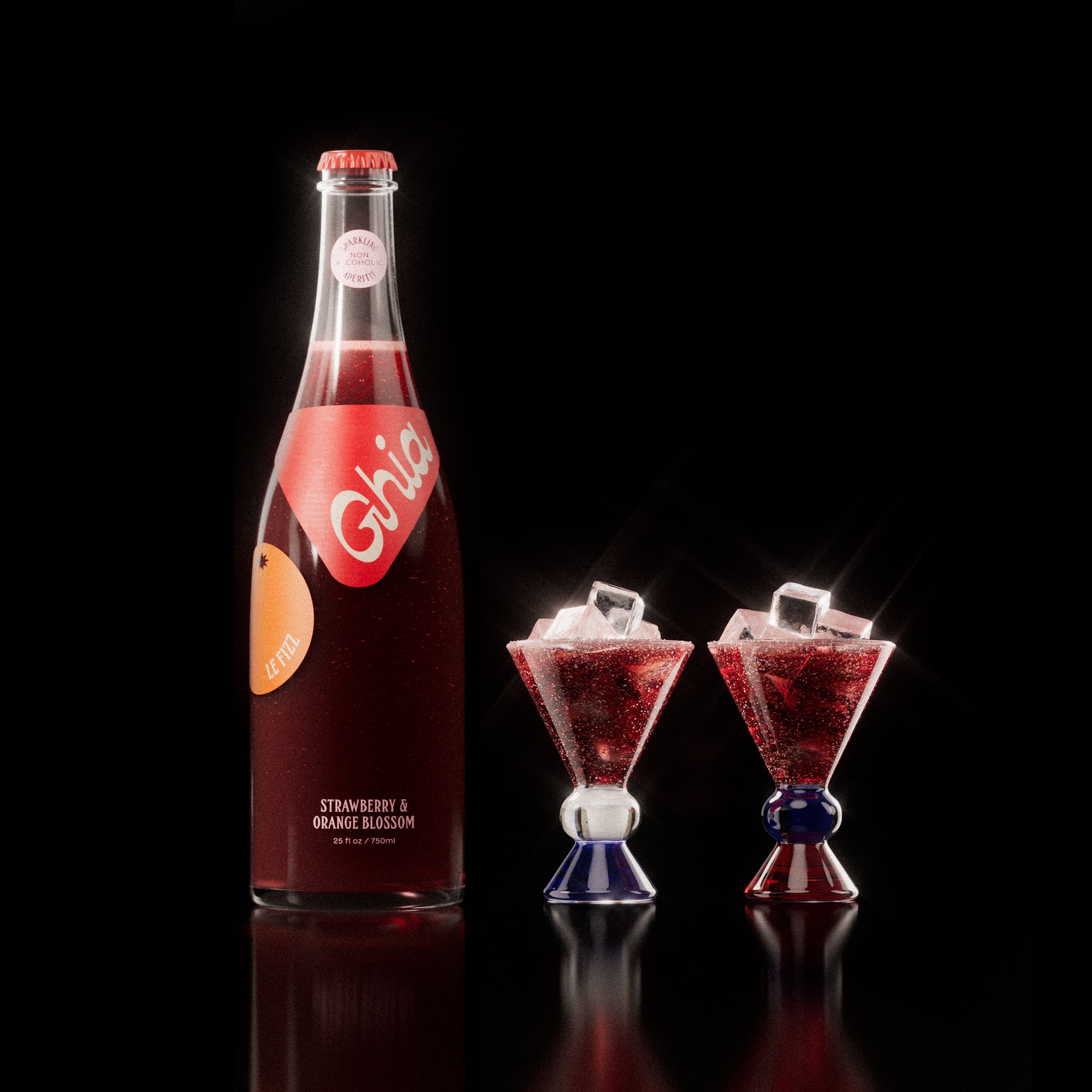 Non-alcoholic spritz in a bottle filled with a deep red strawberry and orange blossom beverage, featuring red labels. Alongside decorative cocktail glass that has a blue and amber base.