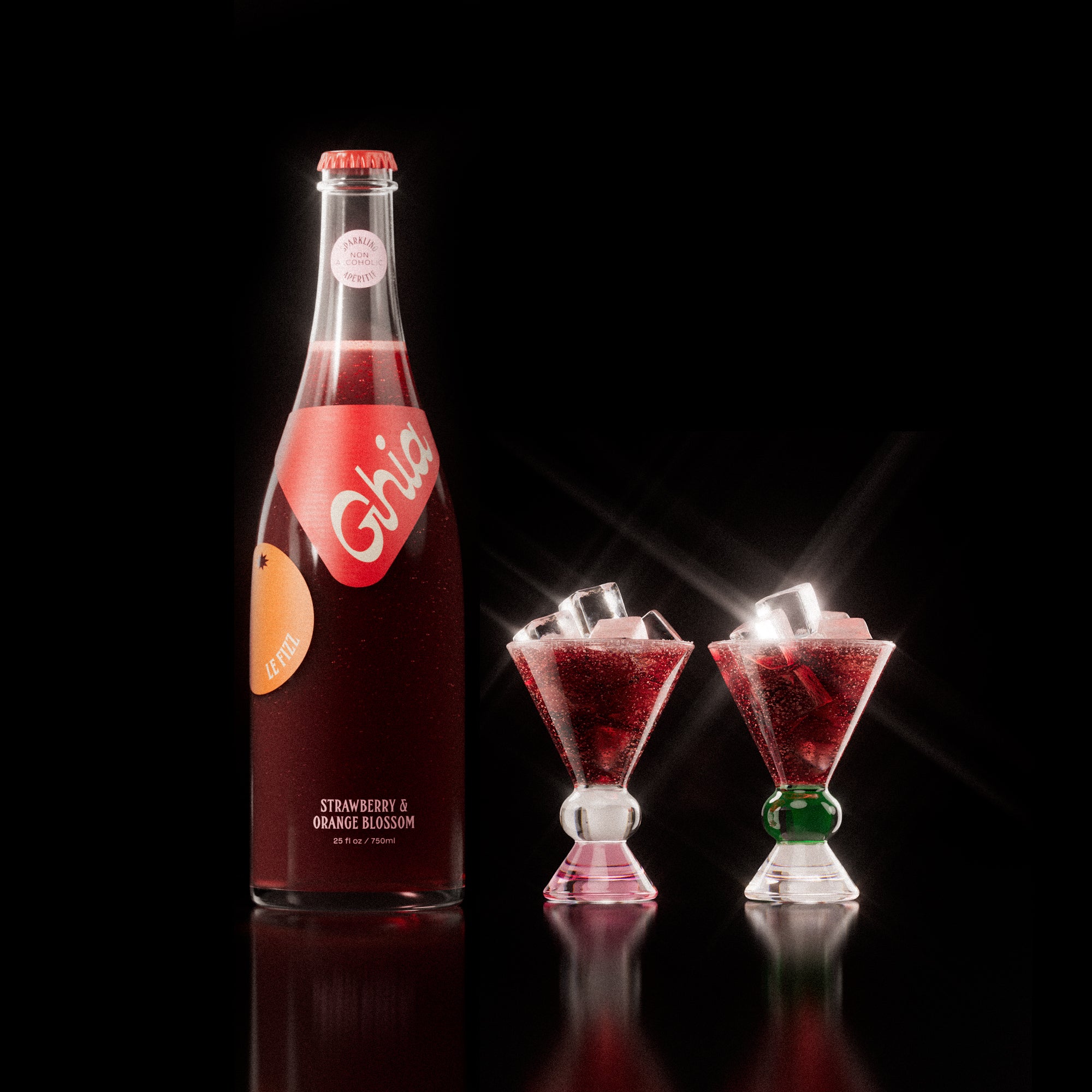 Non-alcoholic spritz in a bottle filled with a deep red strawberry and orange blossom beverage, featuring red labels. Alongside decorative cocktail glass that has a pink, clear and green base.
