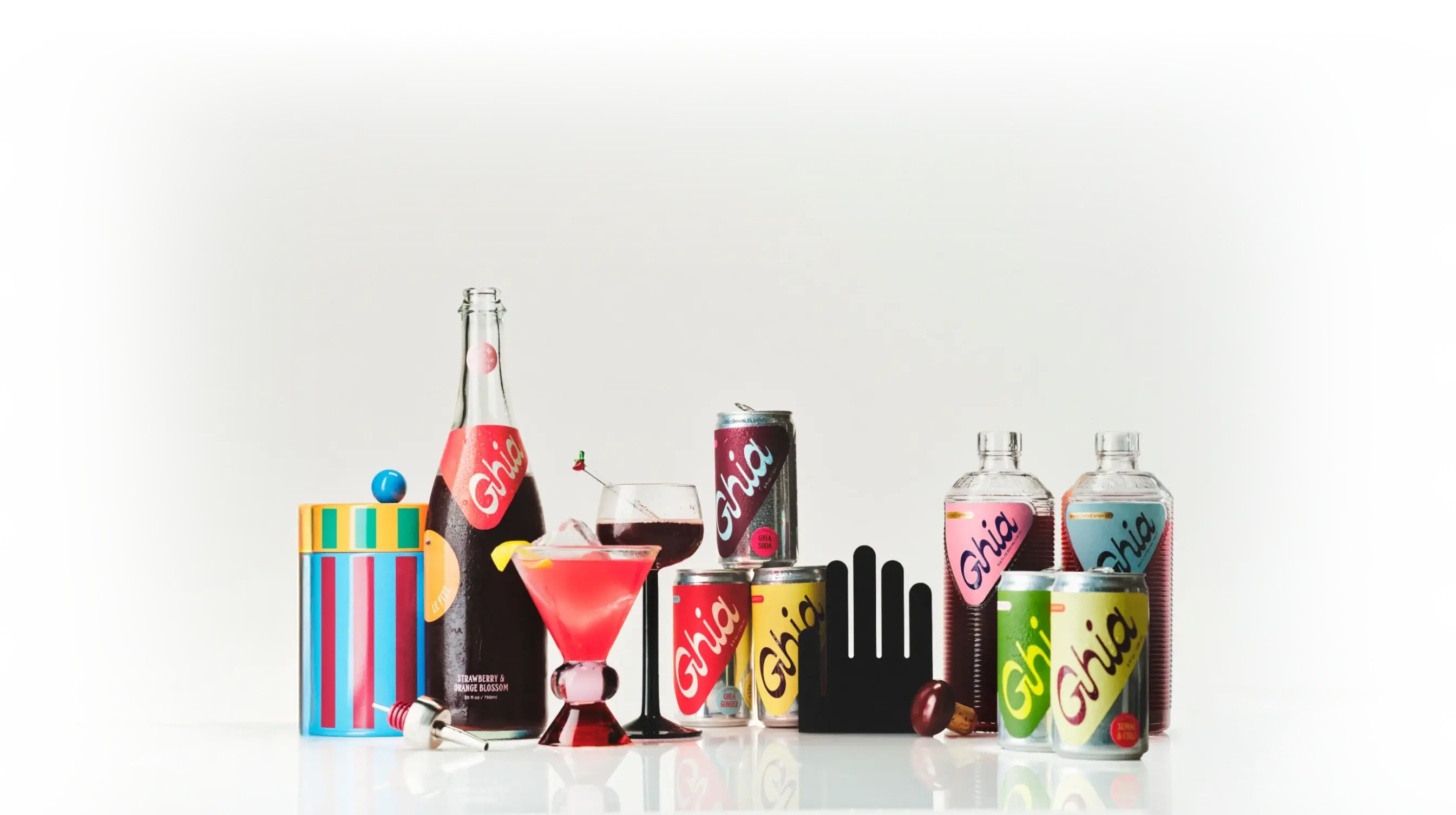 Assortment of Ghia non-alcoholic aperitifs and spritz drinks in vibrant packaging, including bottles, cans, and cocktail glasses, displayed on a white background. The image highlights Ghia's botanical, alcohol-free beverages. Perfect for mindful drinking and cocktail alternatives.