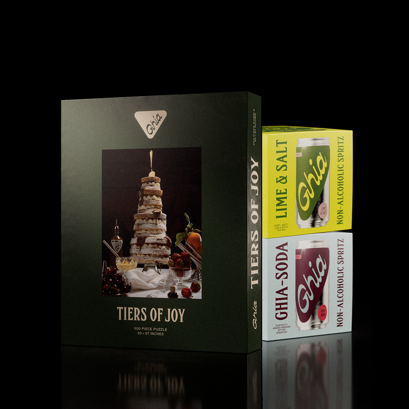 Tiers of Joy puzzle box beside Ghia Lime & Salt and Ghia Soda spritz four-packs