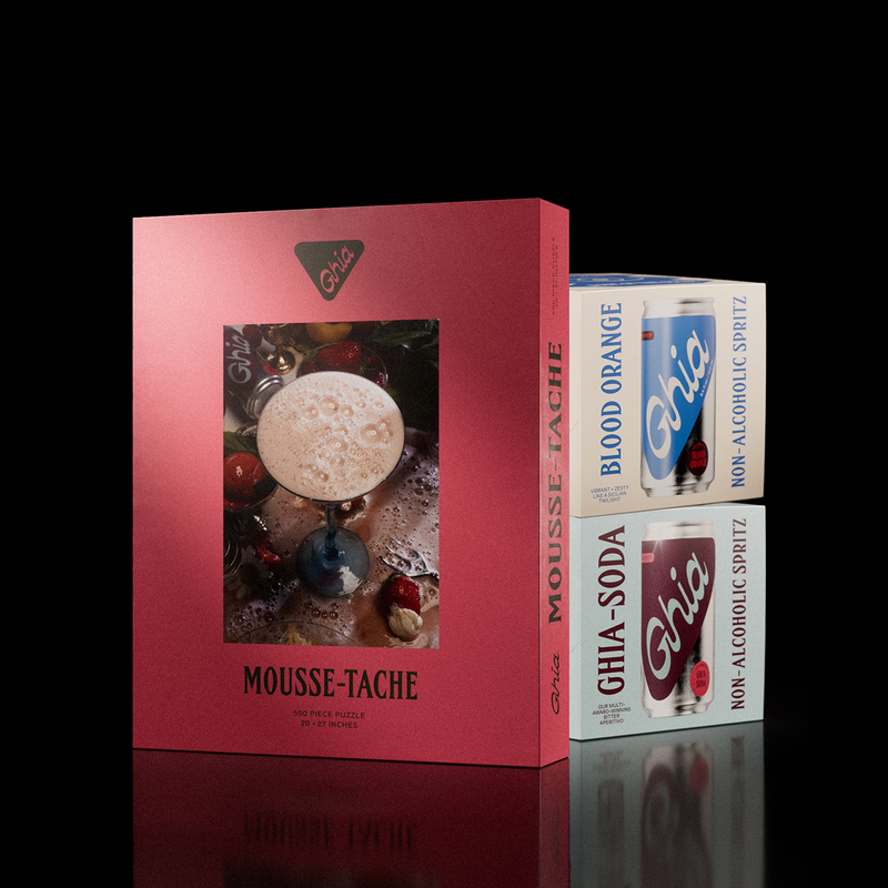 Mousse-Tache puzzle box beside Ghia Blood Orange and Ghia Soda spritz four-packs