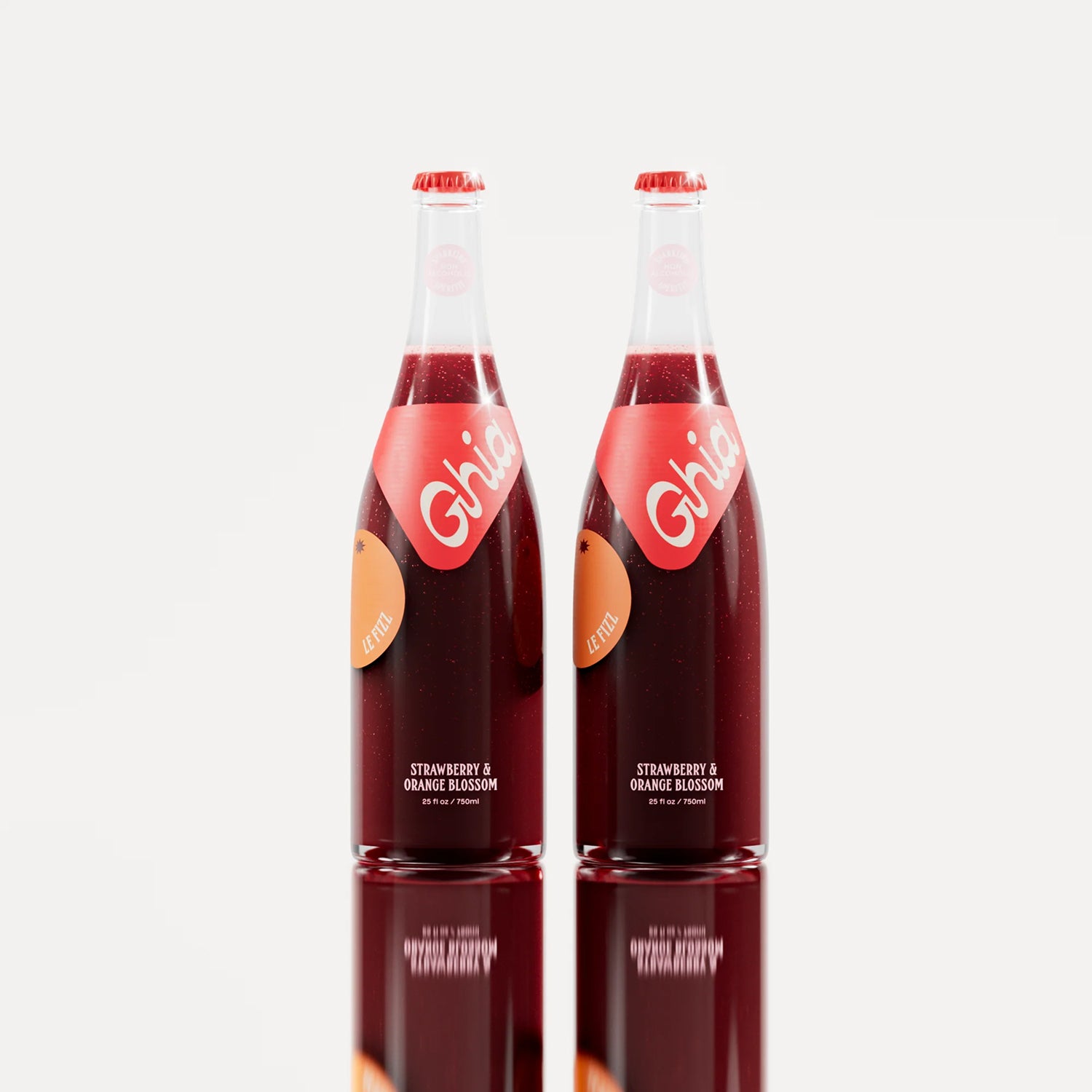 Two non-alcoholic spritz Ghia bottles filled with a deep red strawberry and orange blossom beverage, featuring red labels and sealed with matching red caps.