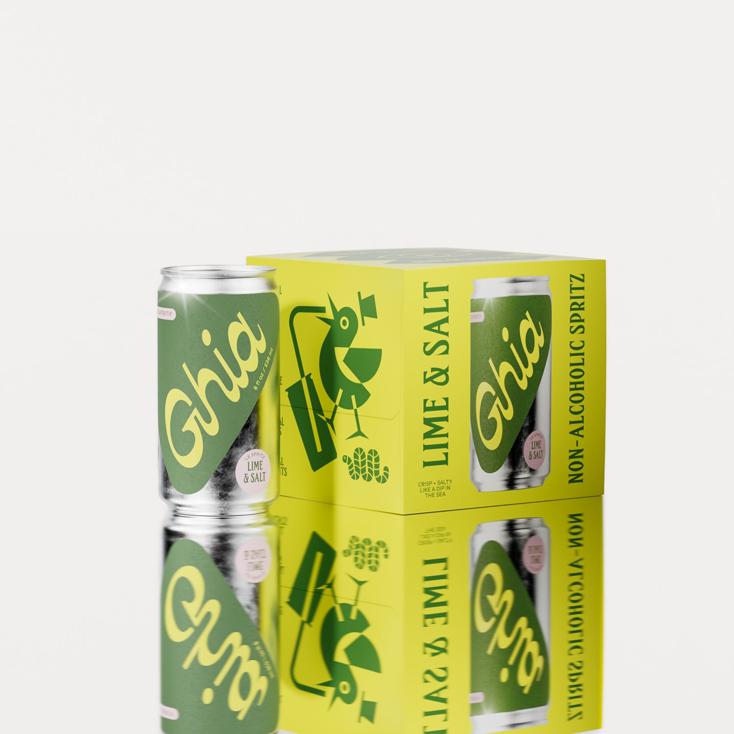 A pack of four Ghia Lime & Salt non-alcoholic spritz cans with a bright yellow box featuring playful illustrations. One can is placed beside the box, reflecting on a surface.