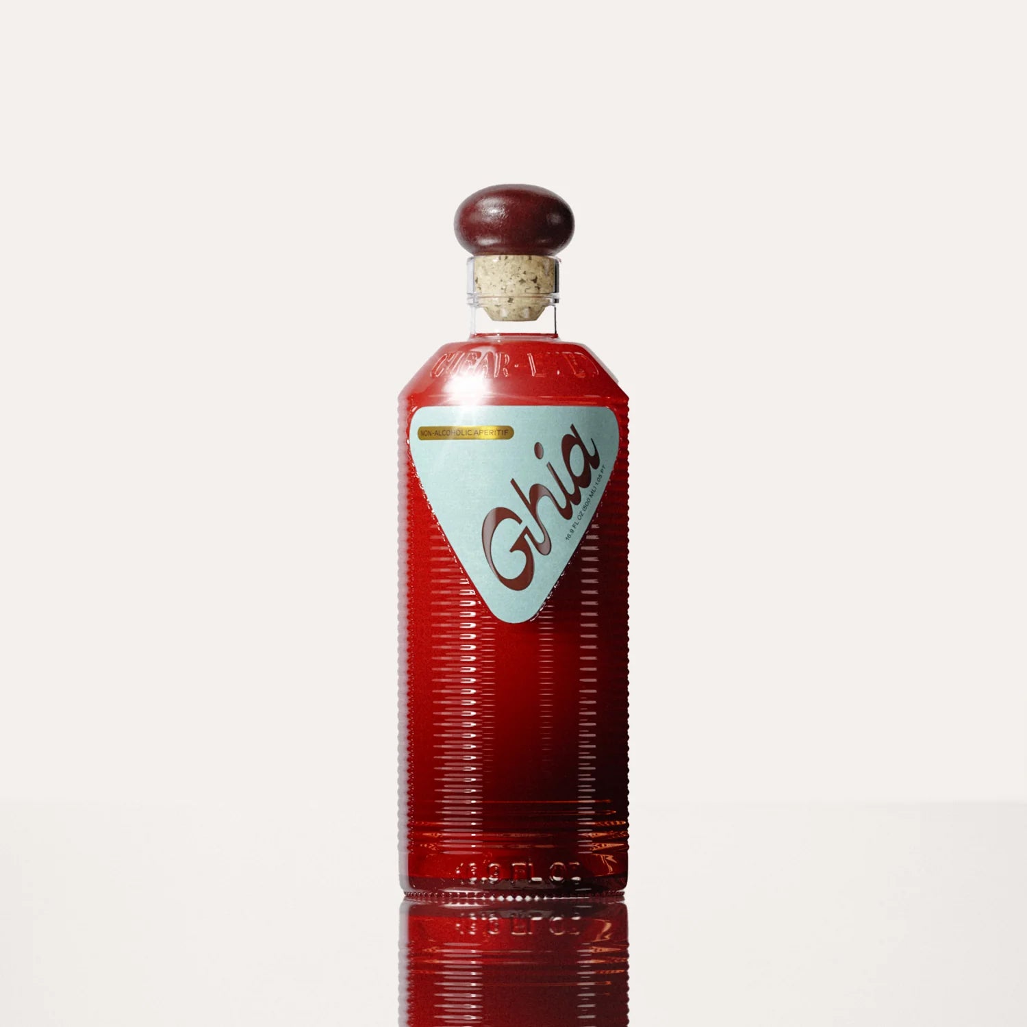 A Ghia non-alcoholic beverage in flavor Original Apéritif bottle with a deep red hue, ribbed glass design, a burgundy cork top, and a light blue label featuring bold branding.