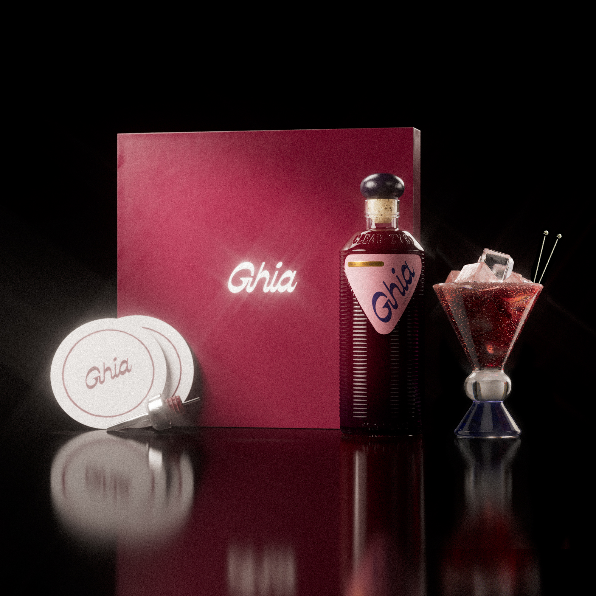 A Ghia non-alcoholic aperitif gift set with a burgundy box, paper coasters, 1 glass bottle of Berry Apéritif, and a decorative cocktail glass that has a clear and blue base.