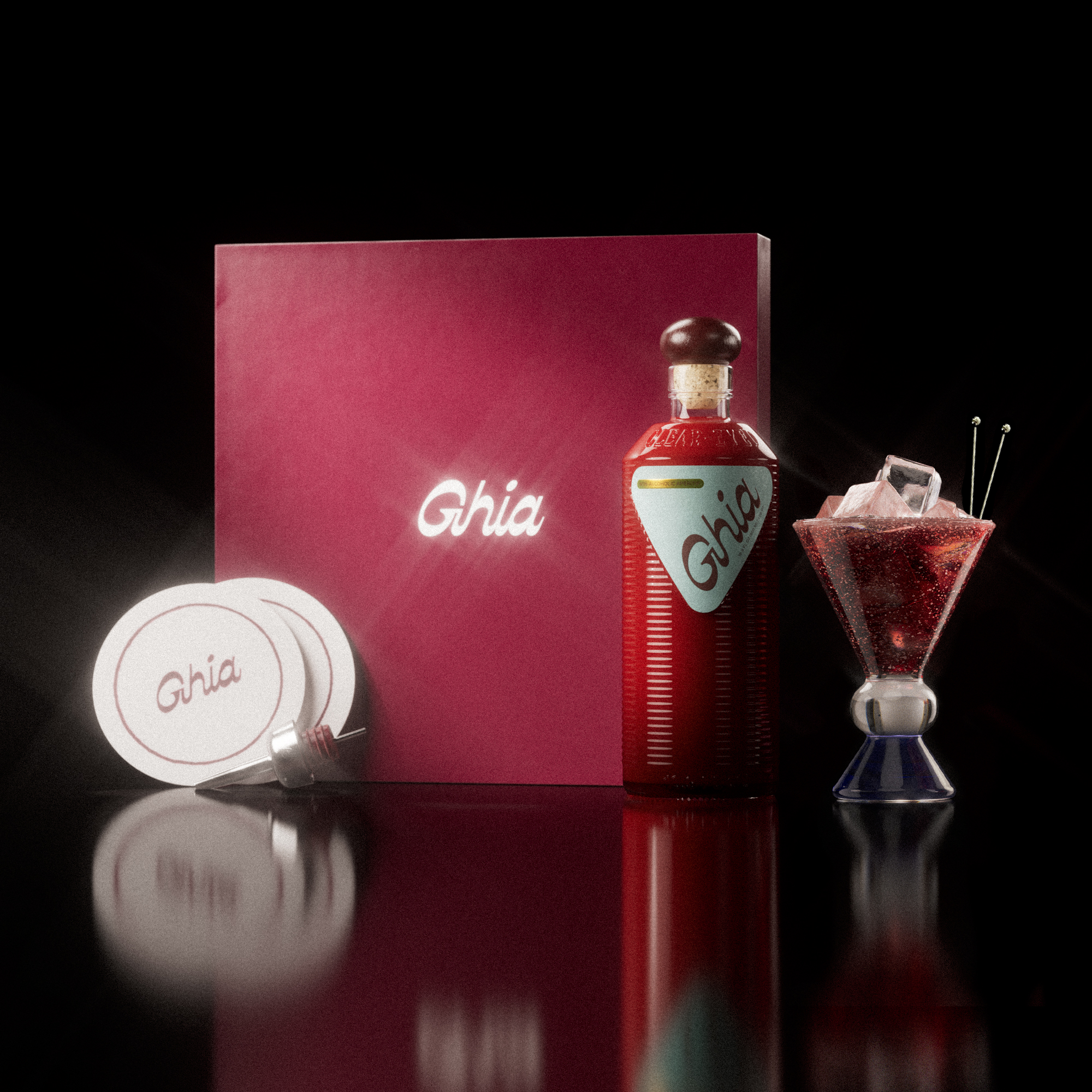 A Ghia non-alcoholic aperitif gift set with a burgundy box, paper coasters, 1 glass bottle of Original Apéritif, and a decorative cocktail glass that has a clear and blue base.
