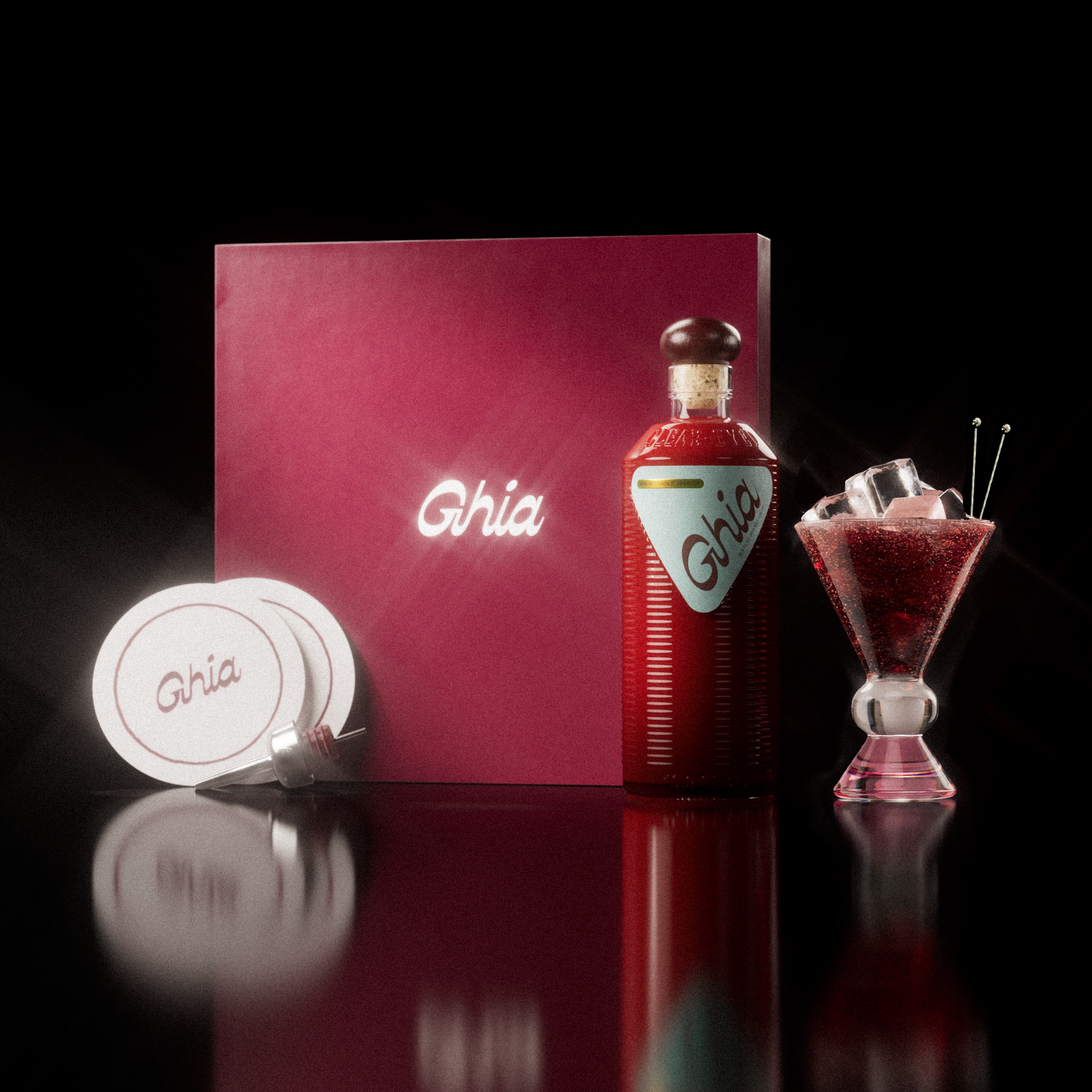 A Ghia non-alcoholic aperitif gift set with a burgundy box, paper coasters, 1 glass bottle of Original Apéritif, and a decorative cocktail glass that has a clear and pink base.