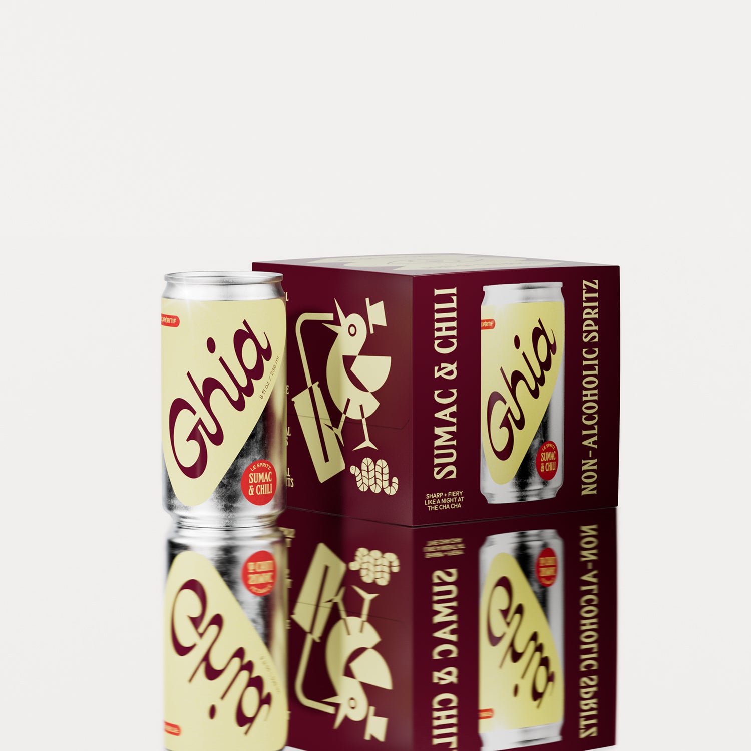 A pack of four Ghia Sumac & Chili non-alcoholic spritz cans with a maroon box featuring playful illustrations. One can is placed beside the box, reflecting on a surface.