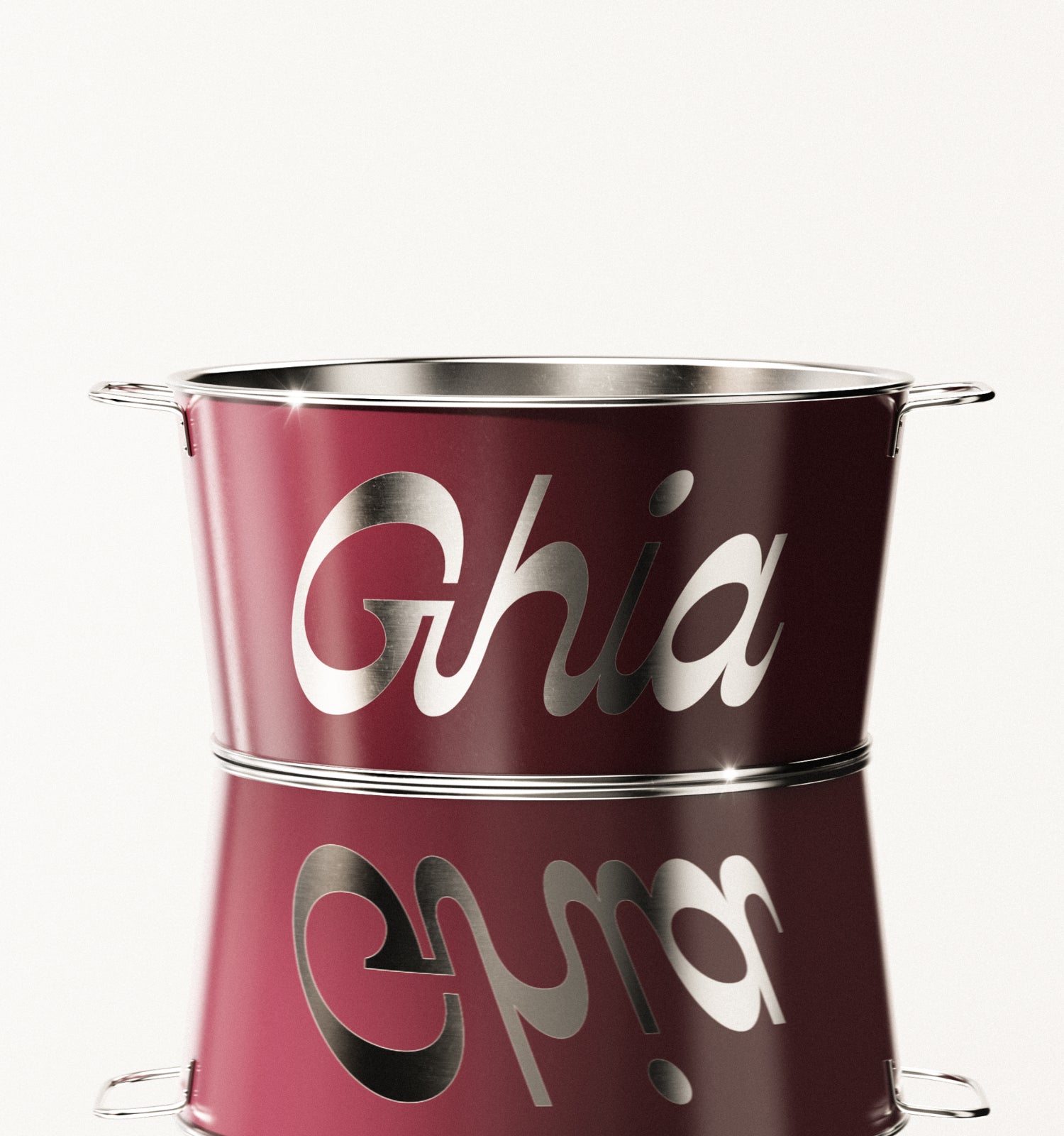 A burgundy Ghia-branded metal ice bucket with silver lettering and handles on both sides, reflecting light on its polished surface.