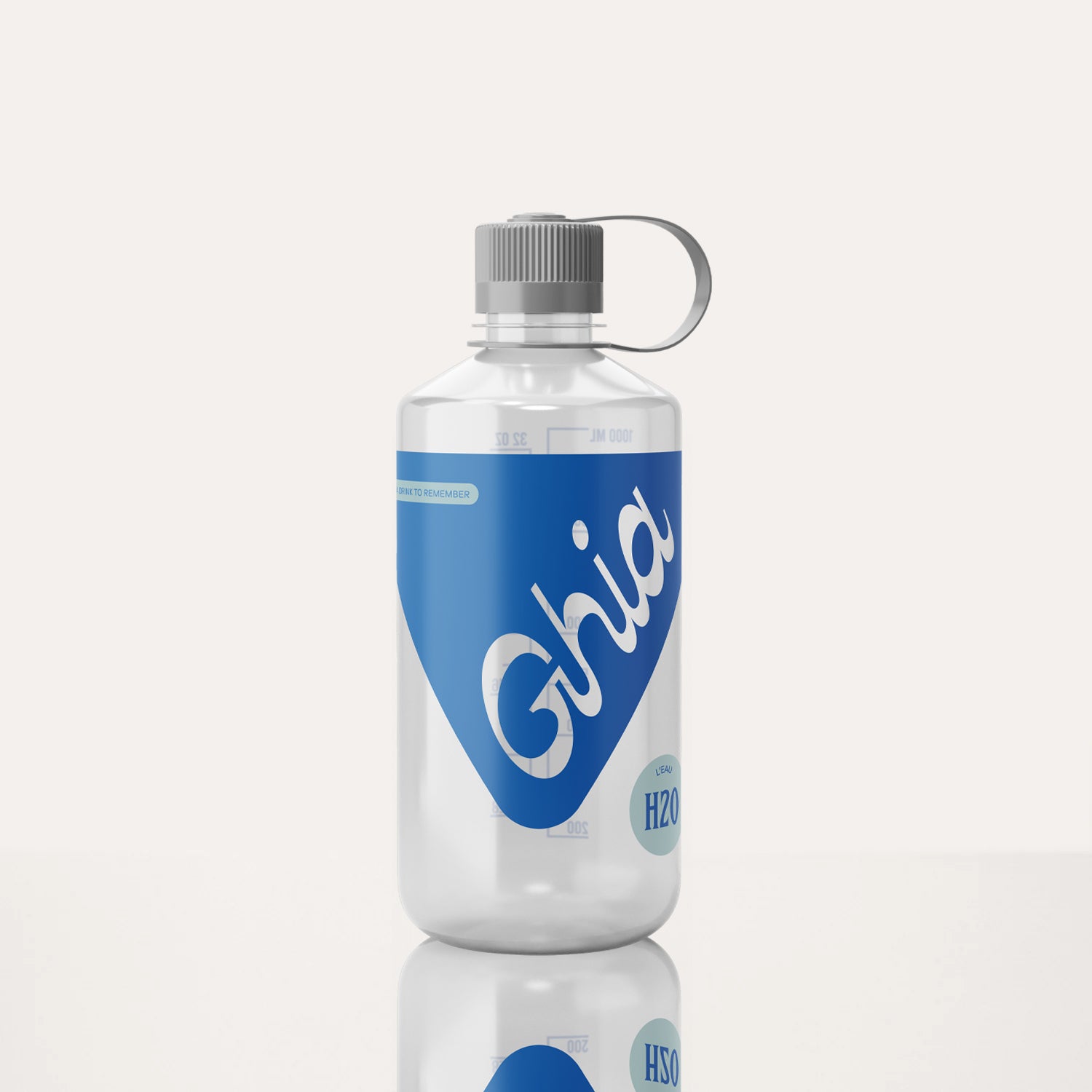 A clear Ghia-branded water bottle with a blue label, white lettering, a gray screw-on cap, and a carrying loop on the side.