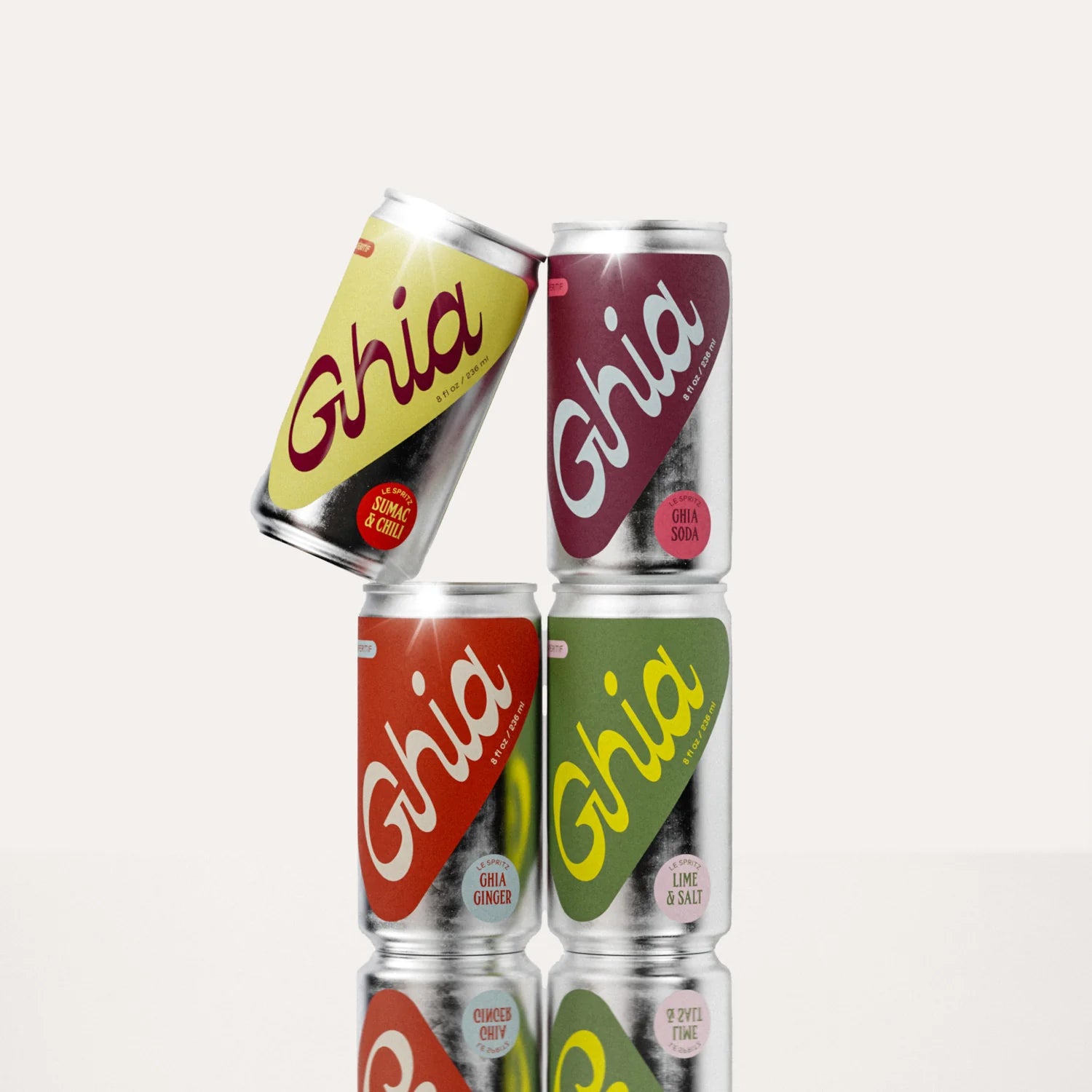 A collection of non-alcoholic spritz cans in vibrant colors, including flavors like Sumac & Chili, Ghia Soda, Ghia Ginger, and Lime & Salt. A refreshing, alcohol-free aperitif designed for mindful drinking