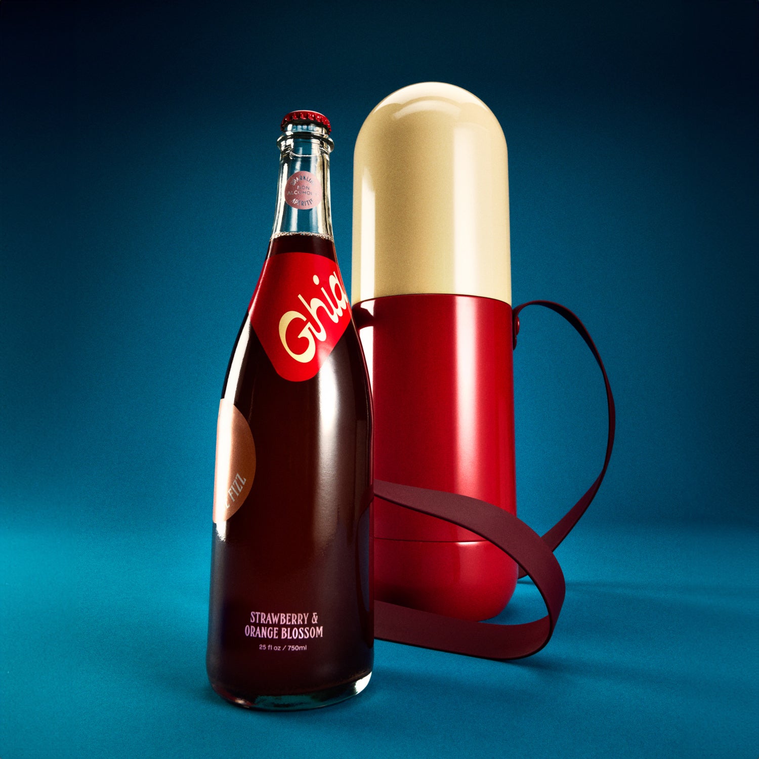 Non-alcoholic spritz in a bottle filled with a deep red strawberry and orange blossom beverage, featuring red labels alongside a red and cream colored cooler shapped like a pill.