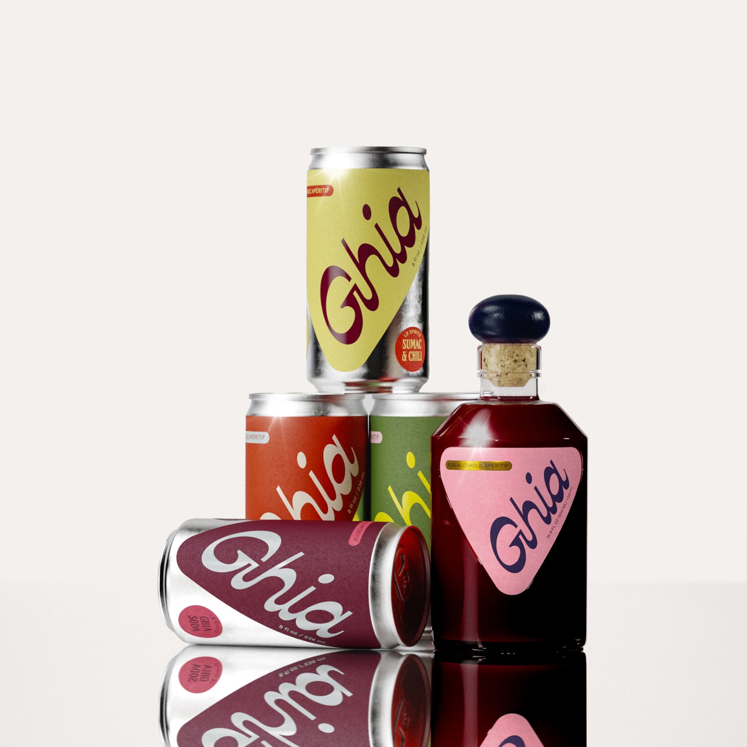 A mini glass bottle of non-alcoholic Berry Apéritif with stacked non-alcoholic spritz cans in yellow, orange, green, and berry hues that represent the 4 flavors (Ghia-Soda, Ghia-Ginger, Lime & Salt, Sumac & Chili)