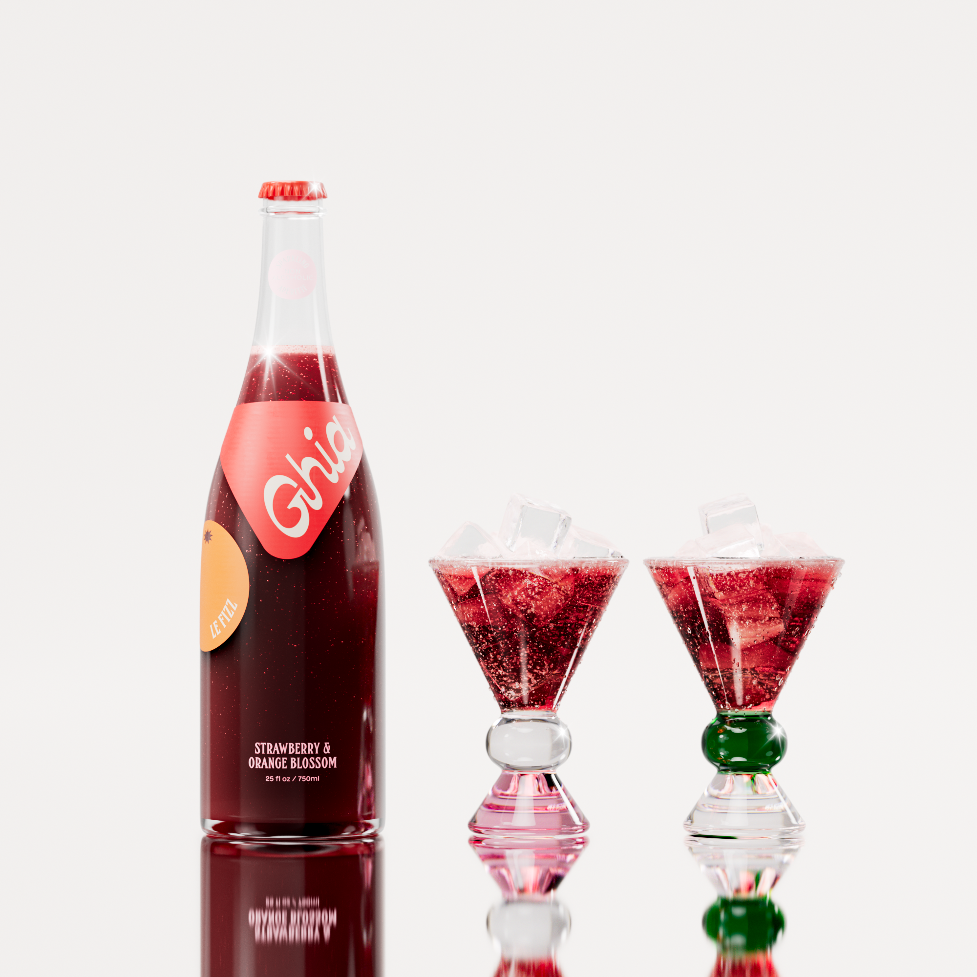 Non-alcoholic spritz in a bottle filled with a deep red strawberry and orange blossom beverage, featuring red labels. Alongside decorative cocktail glass that has a pink, clear and green base.